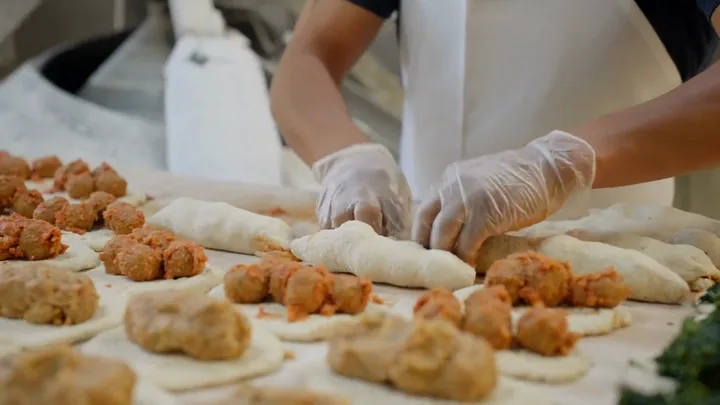 Calzones being filled in the bakery