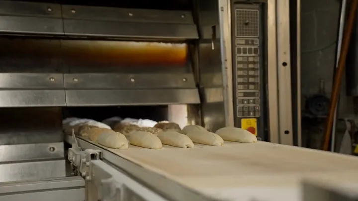 Loaves being loaded into the bakery oven